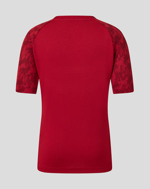 Back view of red Saracens junior training short sleeve tee with patterned sleeves.
