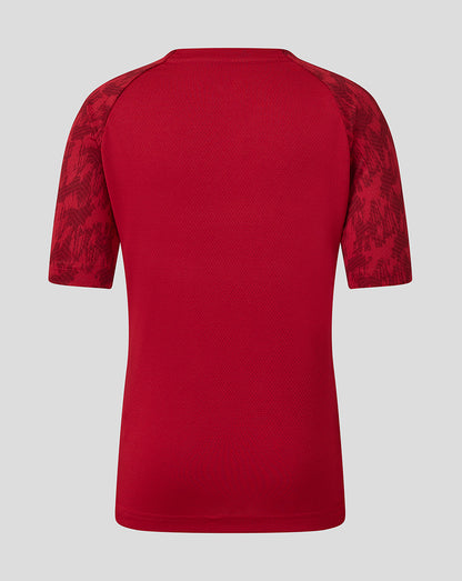 Back view of red Saracens junior training short sleeve tee with patterned sleeves.