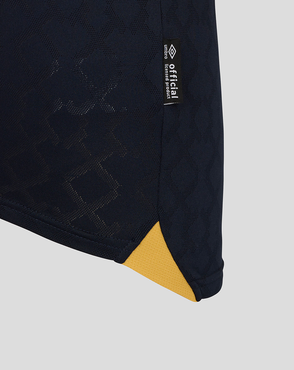 Close-up of West Ham Junior 25/26 Third Kit navy fabric with subtle pattern and small official tag at the hem