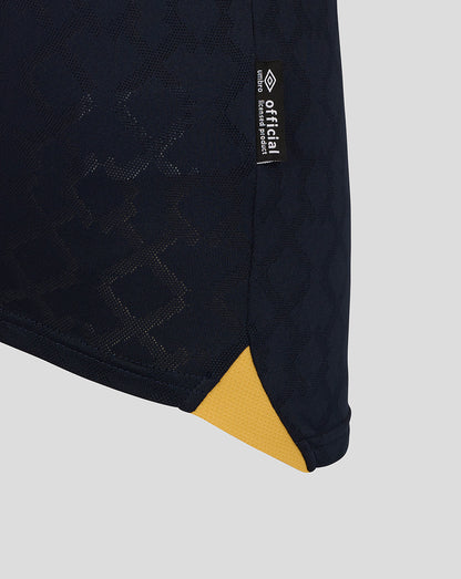 Close-up of West Ham Junior 25/26 Third Kit navy fabric with subtle pattern and small official tag at the hem