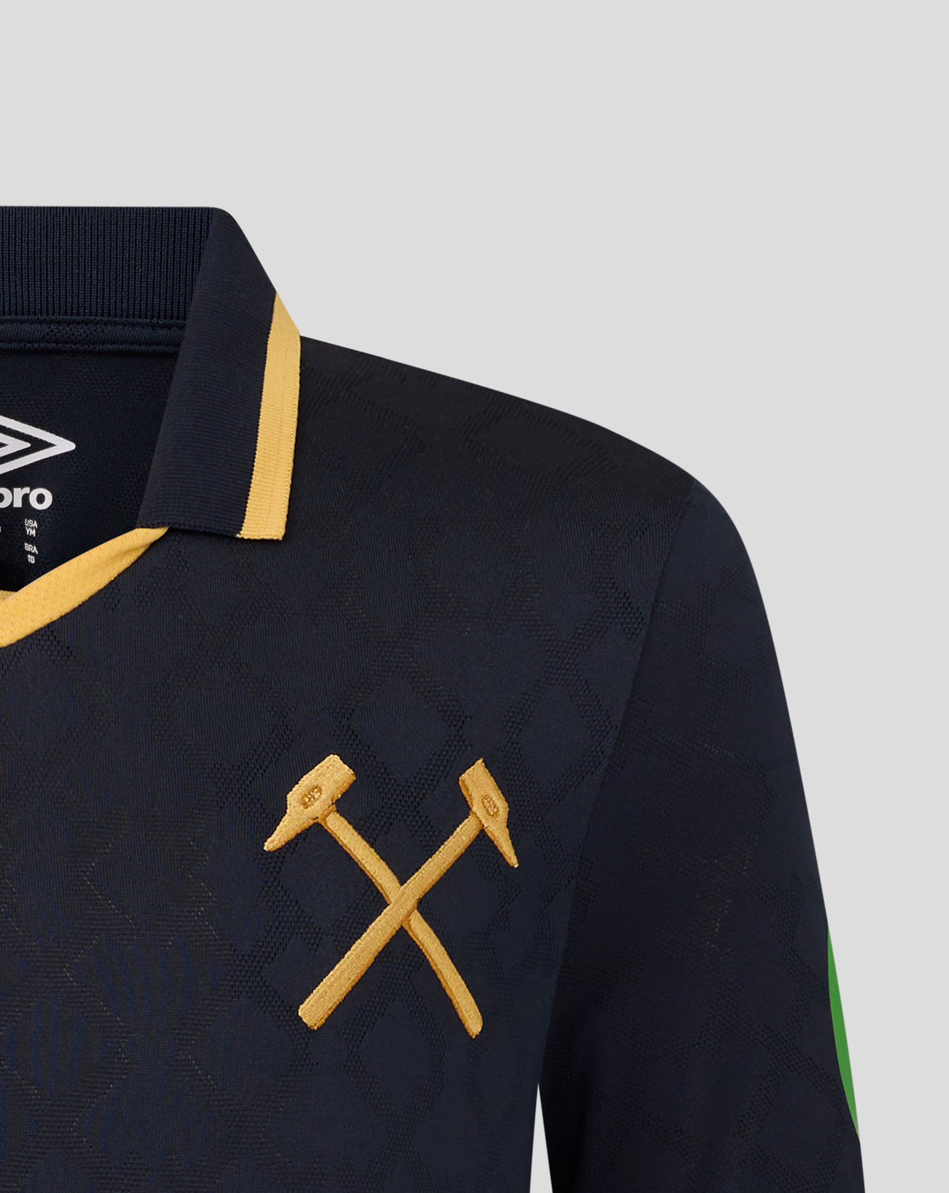 Close-up of navy West Ham Junior 25/26 third kit short sleeve shirt with gold collar trim crossed gold laces and Umbro logo