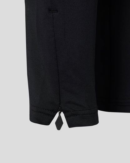 Close-up of dark knit fabric with ankle zipper on West Ham Junior Pro Training Knit Pants
