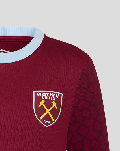 Front close-up of West Ham Junior Home shirt showing crest and Umbro logo on maroon fabric with light blue collar