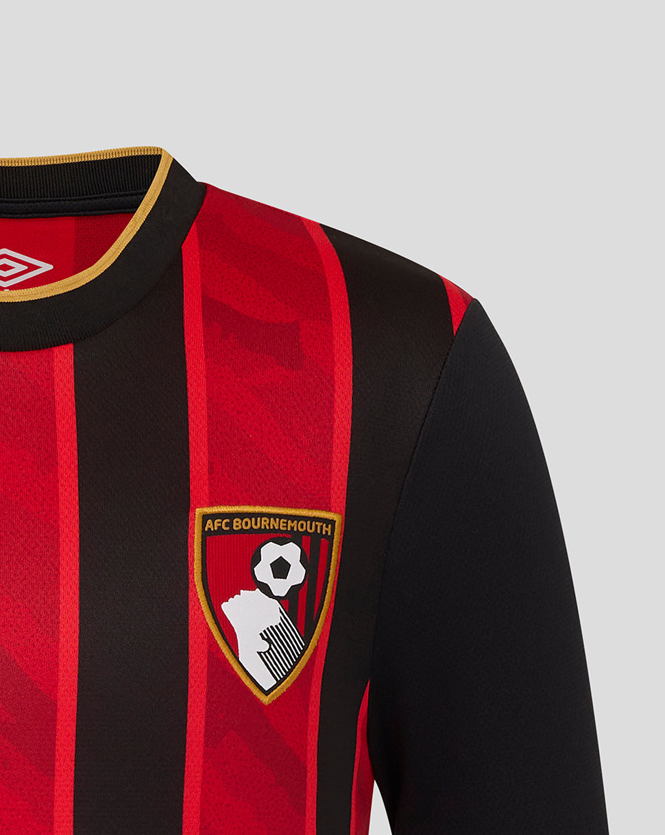 Chest detail showing the AFC Bournemouth crest and Umbro logo on the red and black striped junior home shirt.