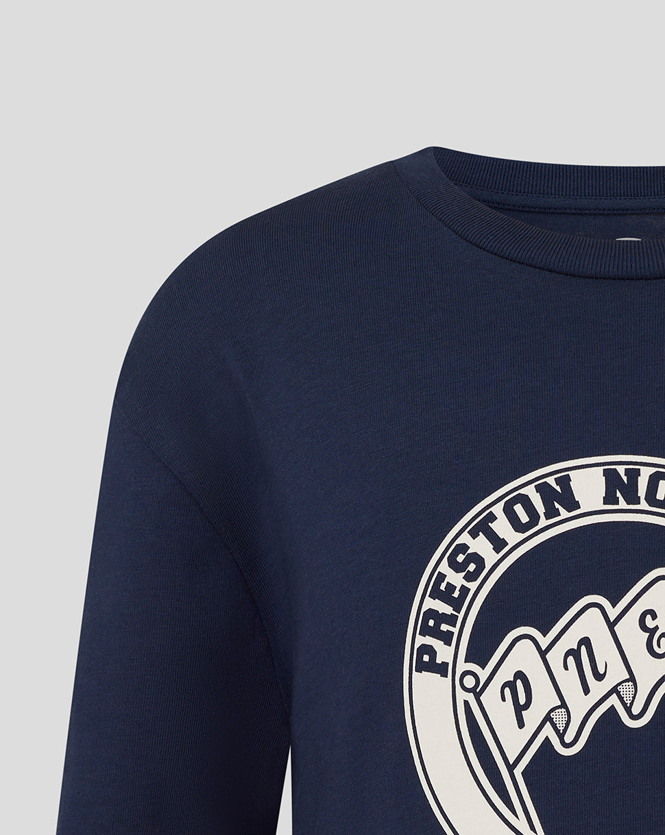 Close-up of navy Preston North End T-shirt with white circular logo.