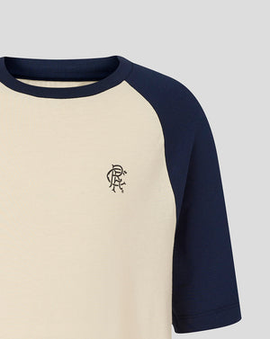 Cream body with navy sleeves Rangers Junior Raglan Tee featuring a small scroll crest on the chest.