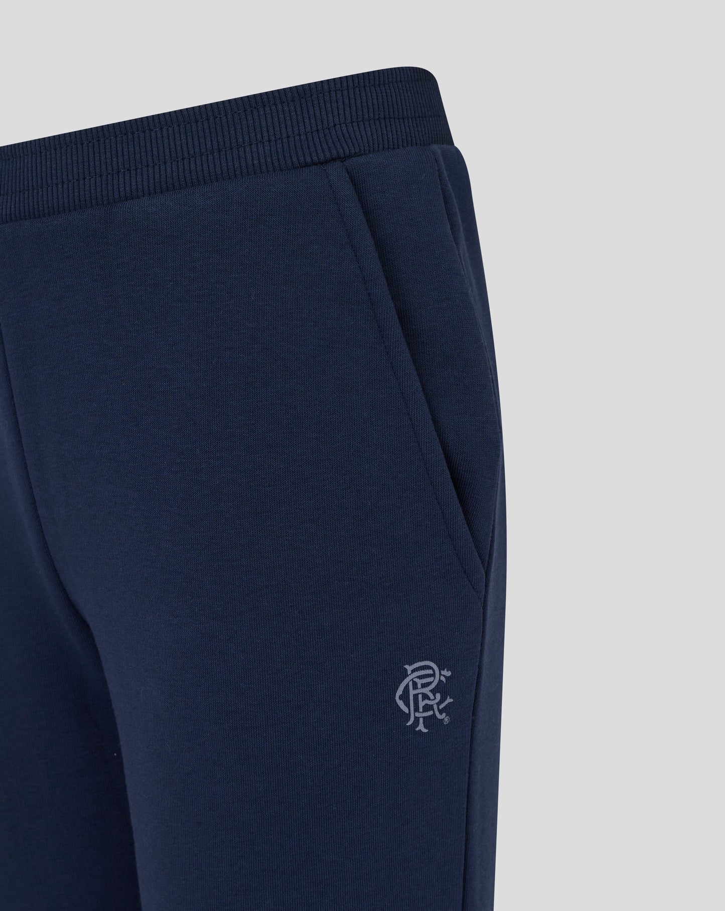 Close up of navy Rangers joggers fabric with side pocket and crest on the thigh