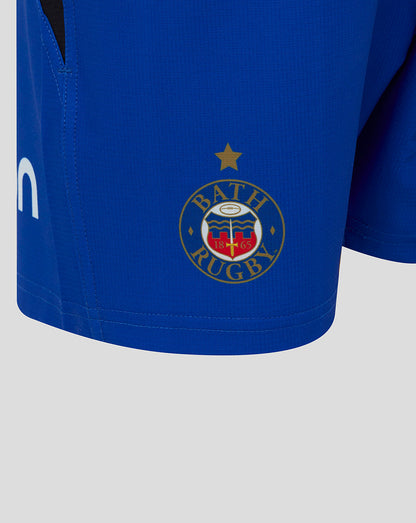 Close up of Bath Rugby junior shorts showing Bath crest on the left leg and Castore logo on the right leg