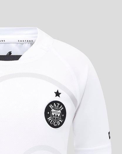 Close up of Bath Rugby crest and star on white junior away replica shirt