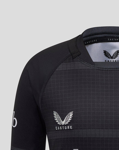 Shoulder and upper chest of Bath Rugby Junior replica shirt with grid texture and Castore branding on inside collar