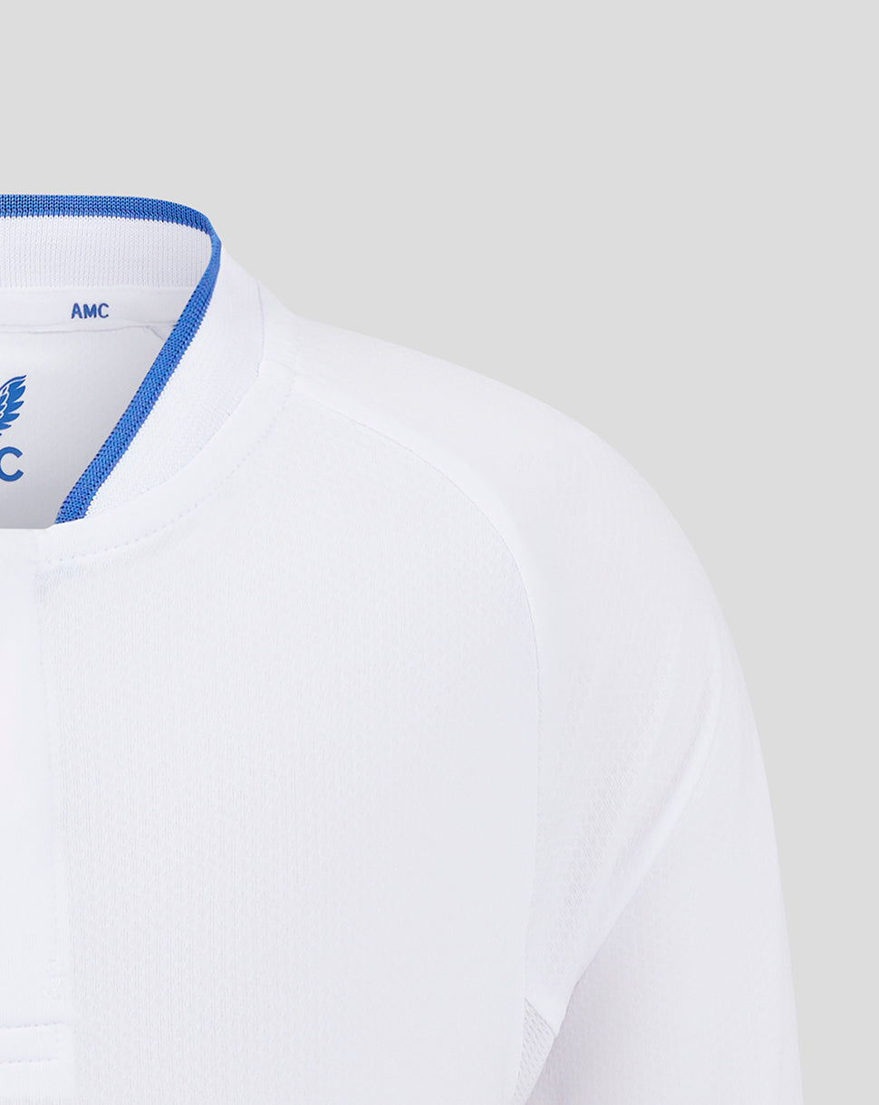 Close up of white polo collar with blue trim and AMC label at the neck