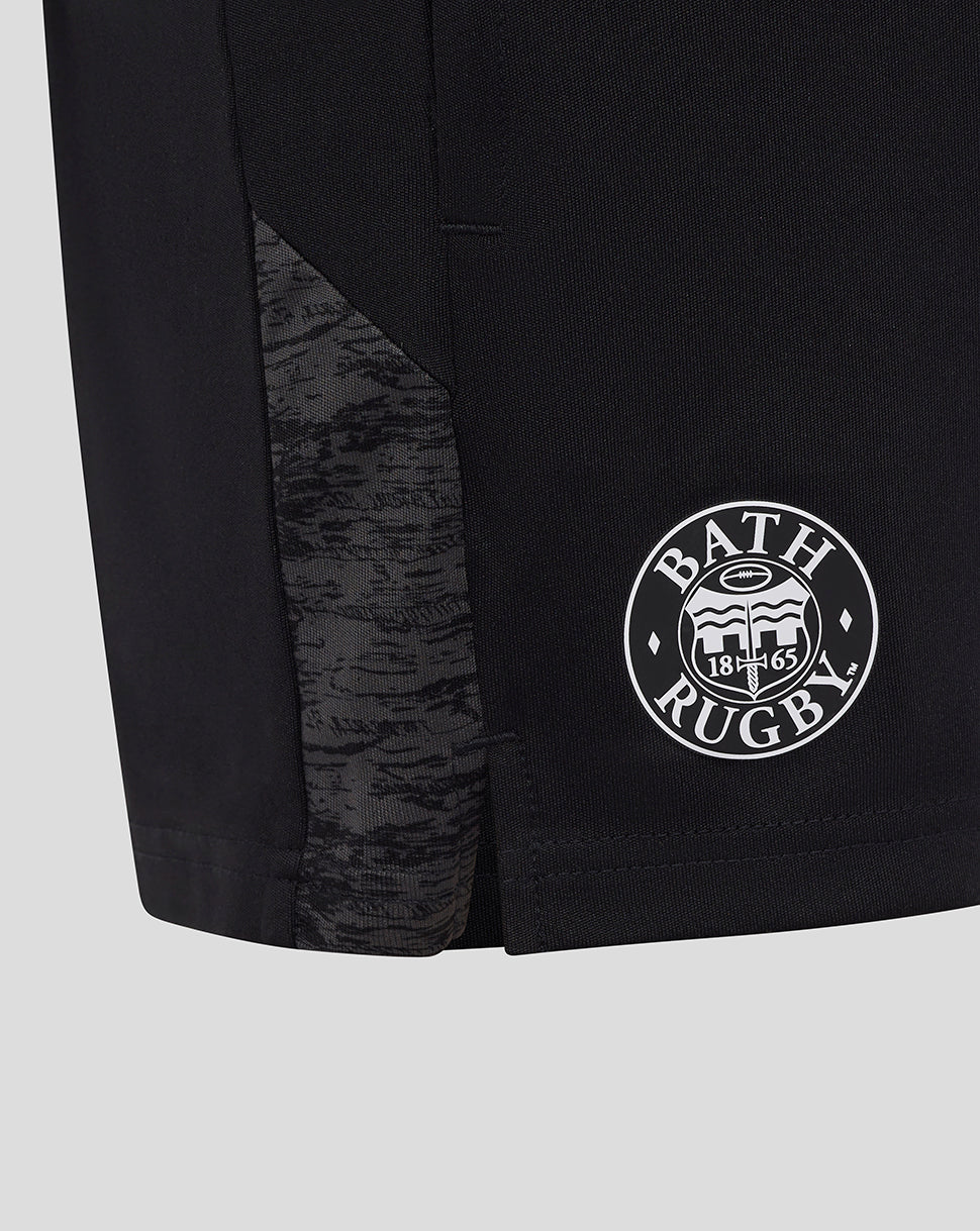 Close-up of the lower leg showing a camo panel and Bath Rugby badge on black shorts.