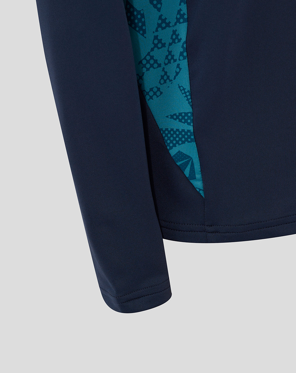 Close up of navy junior England midlayer sleeve with teal abstract print.