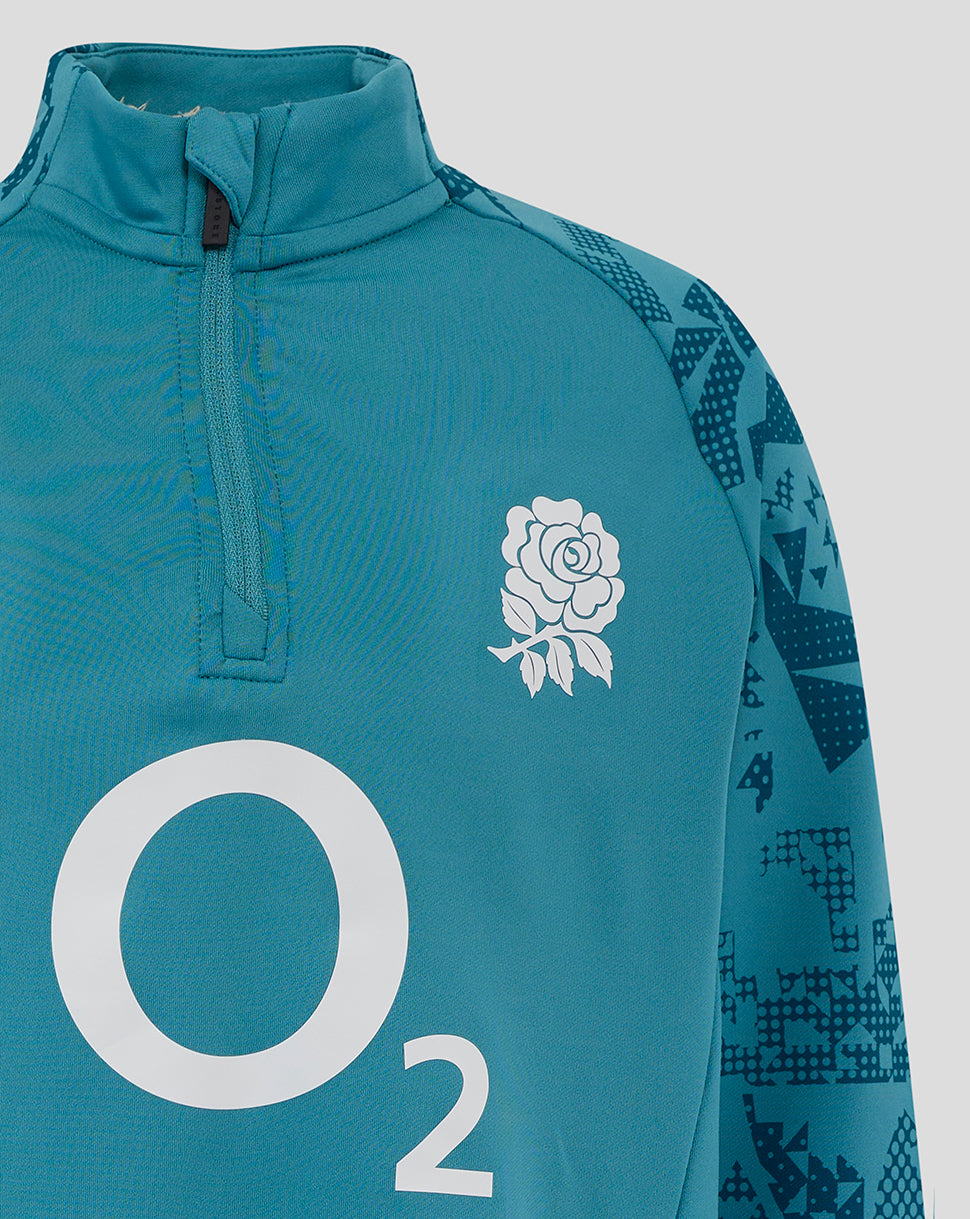 Close-up of junior England storm blue midlayer with rose crest left chest, large O2 logo center front and quarter-zip.