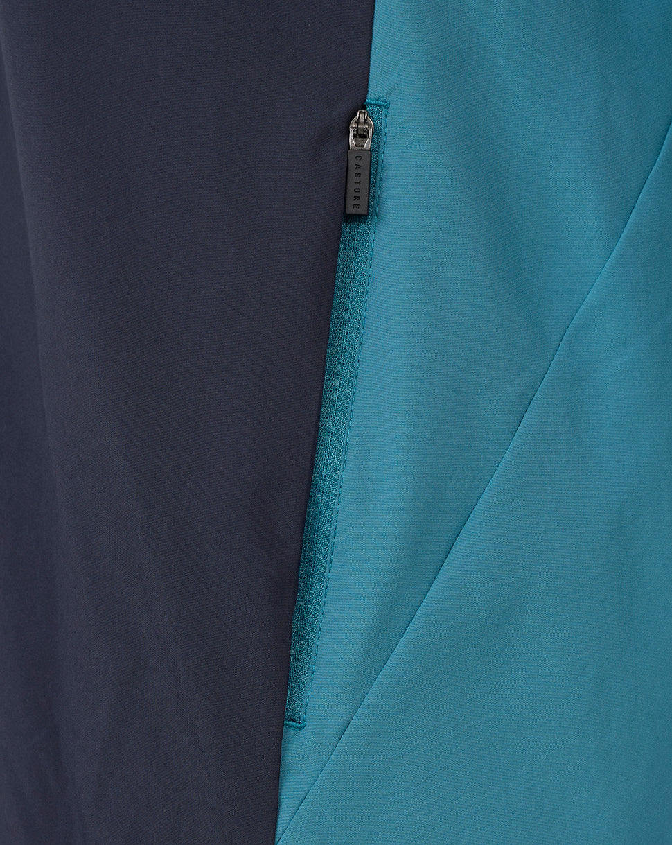 Two-tone color blocked jacket with teal and navy panels and a CASTORE zipper pull.