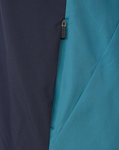 Two-tone color blocked jacket with teal and navy panels and a CASTORE zipper pull.