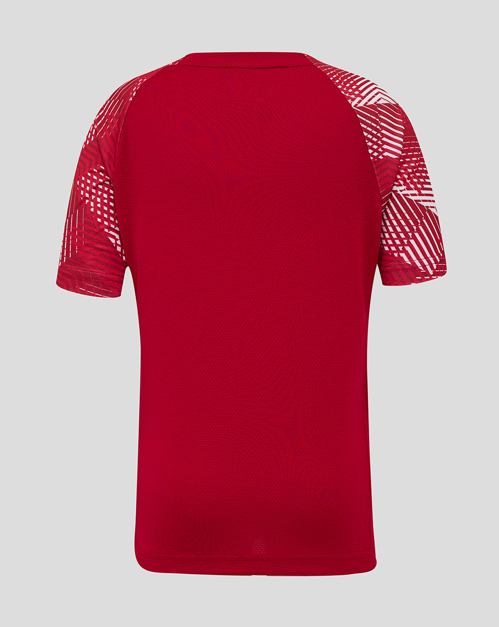 Back view of red England Rugby Junior pre match shirt with geometric white sleeve patterns.