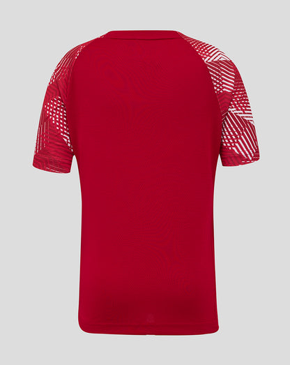 Back view of red England Rugby Junior pre match shirt with geometric white sleeve patterns.