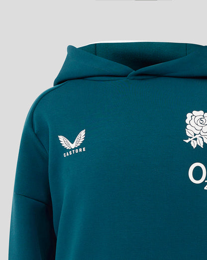 Close up of the teal hoodie shoulder and chest showing Castore logo and a partial white rose graphic.