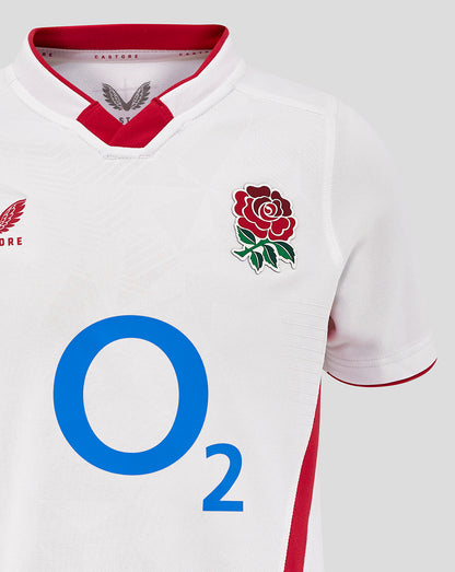 Close-up of the white Junior England Rugby Home Pro Shirt front showing the rose crest and O2 logo on the chest