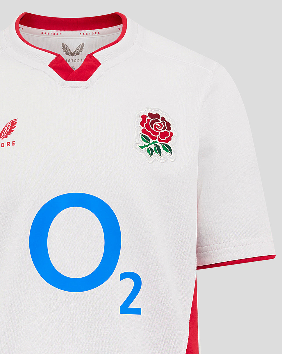 Close-up of front chest on white England rugby shirt showing rose crest on left and large blue O2 logo in center