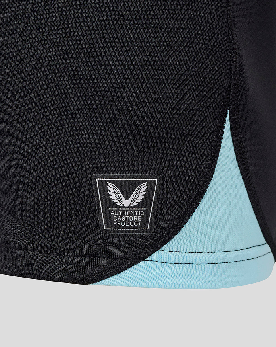 Close up of the jersey hem showing turquoise trim and authentic Castore product badge