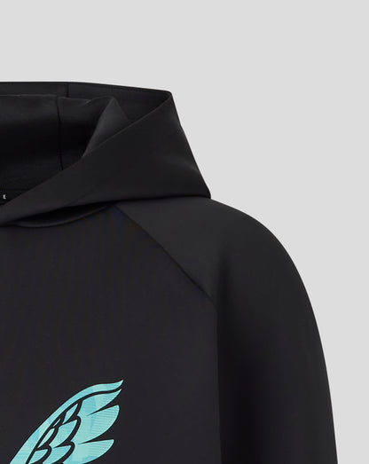 Close up of turquoise wing emblem on the chest of the black hoodie