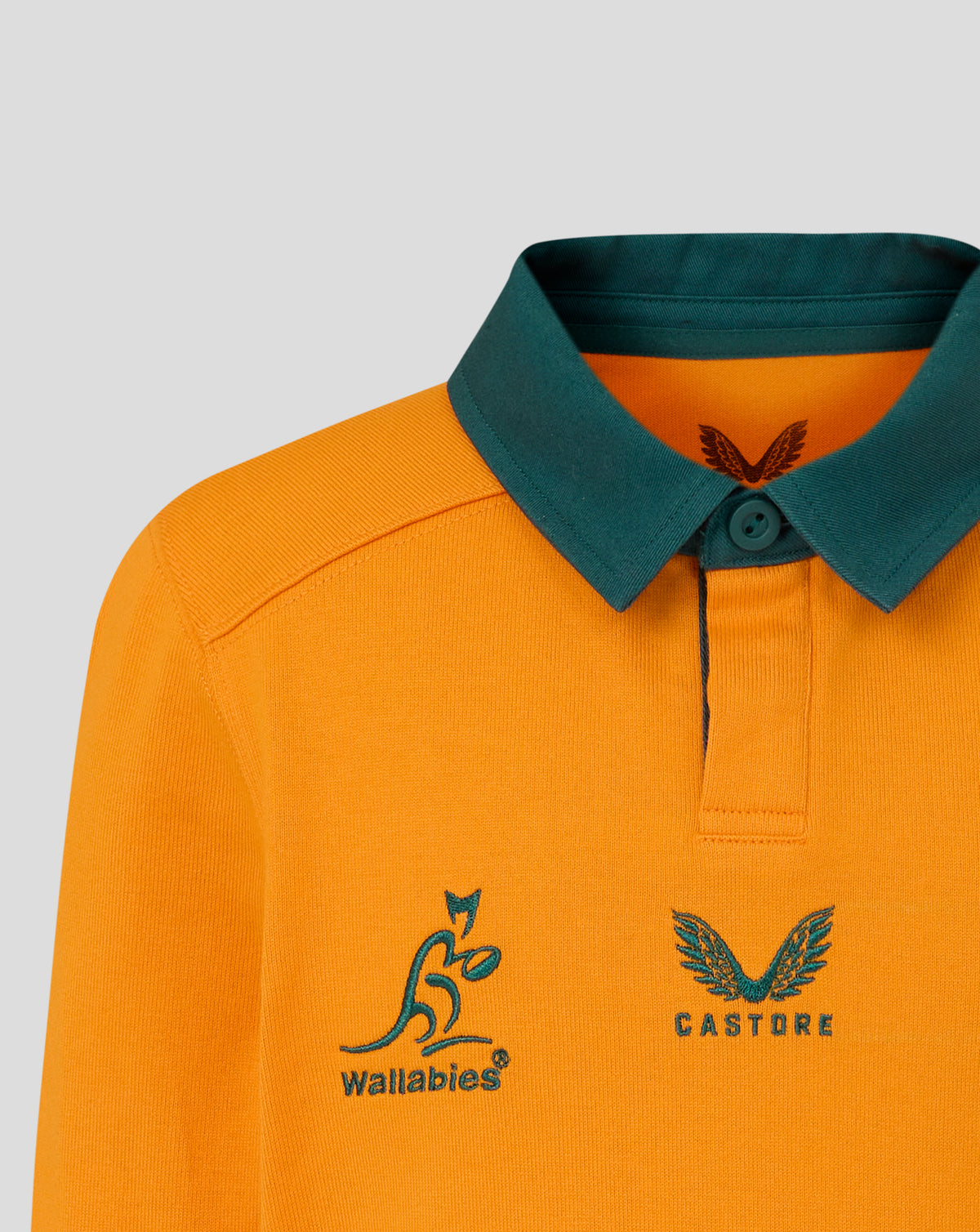 Front view of orange long sleeve rugby shirt with green collar showing Wallabies and Castore logos on chest.