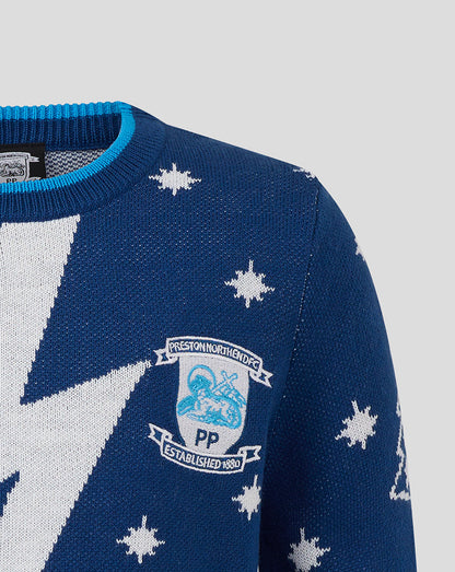Close up of Preston North End Junior Christmas jumper with crest and white star pattern on blue knit.