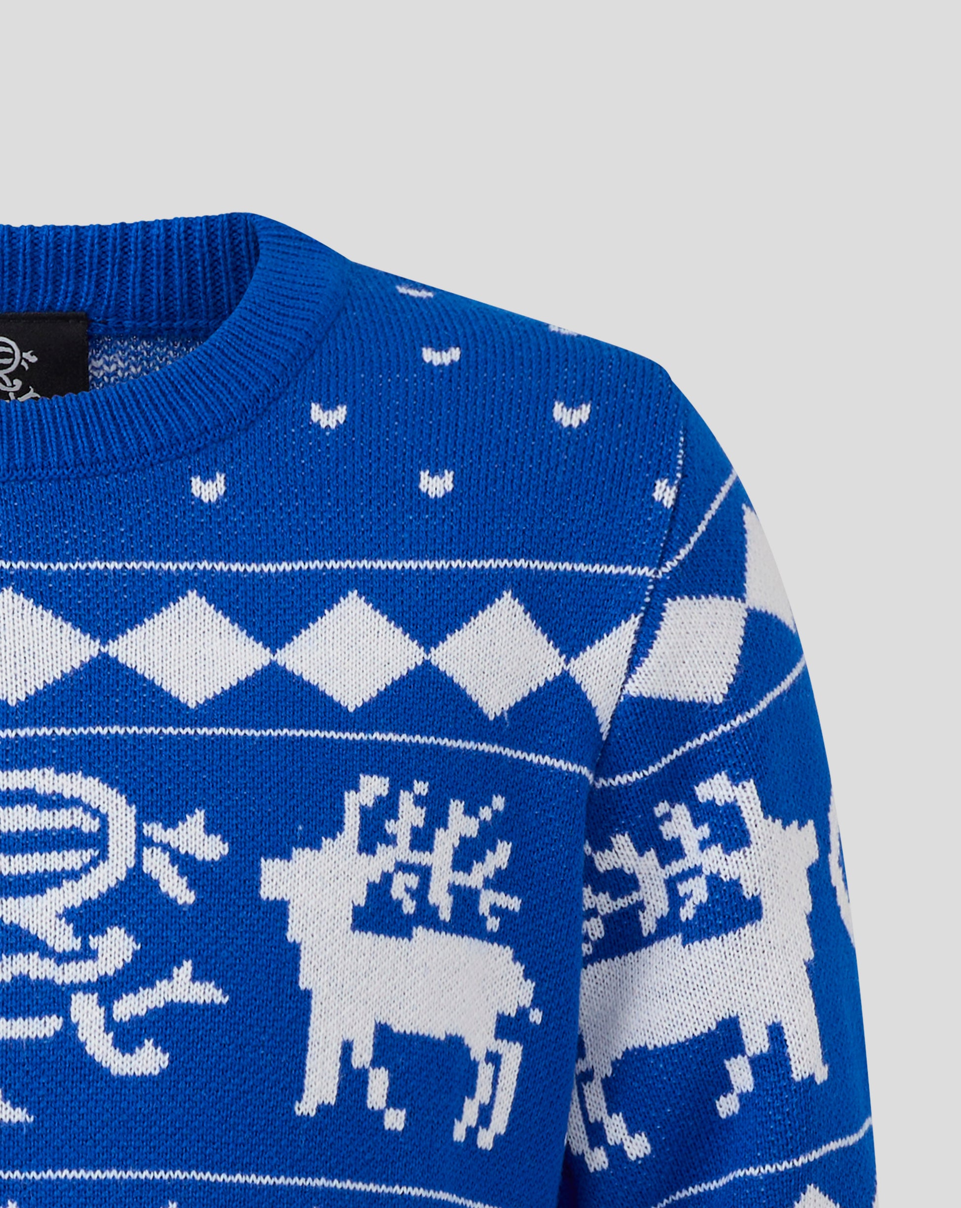 Close up of a blue Rangers junior Christmas jumper with white zigzag pattern and small knitted motifs