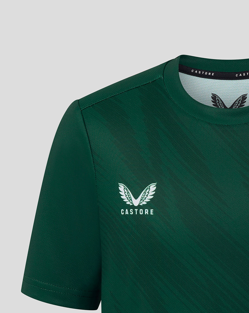 Close up of front of dark green Leicester Tigers junior warm up T shirt showing Castore logo left chest and Breedon emblem