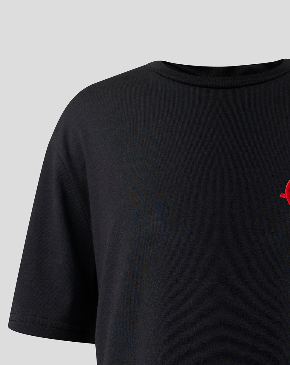 Partial view of the red monogram graphic on the chest of the black Haas T shirt