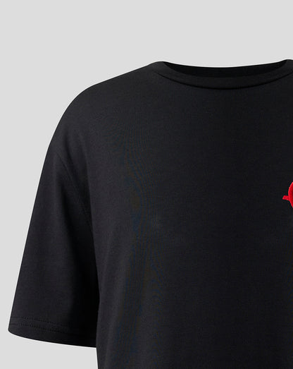 Partial view of the red monogram graphic on the chest of the black Haas T shirt