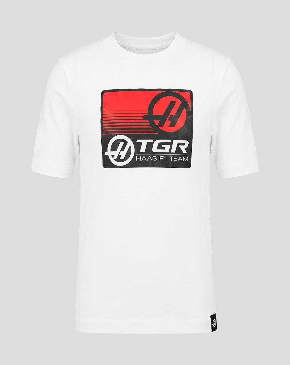 White t-shirt with TGR Haas F1 Team logo on a gray background