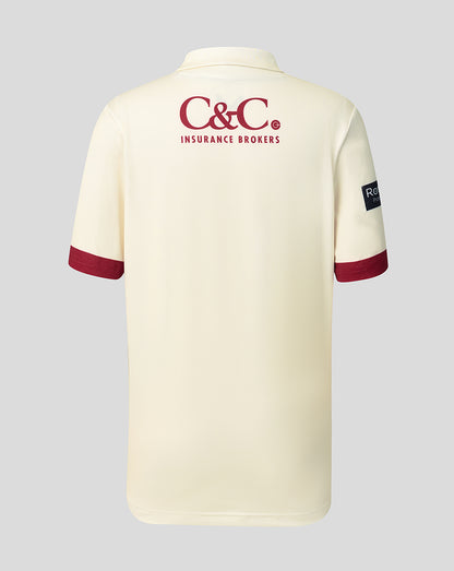 Back view of cream Lancashire Cricket junior County Champs jersey with C&C Insurance Brokers logo across the upper back and maroon sleeve cuffs