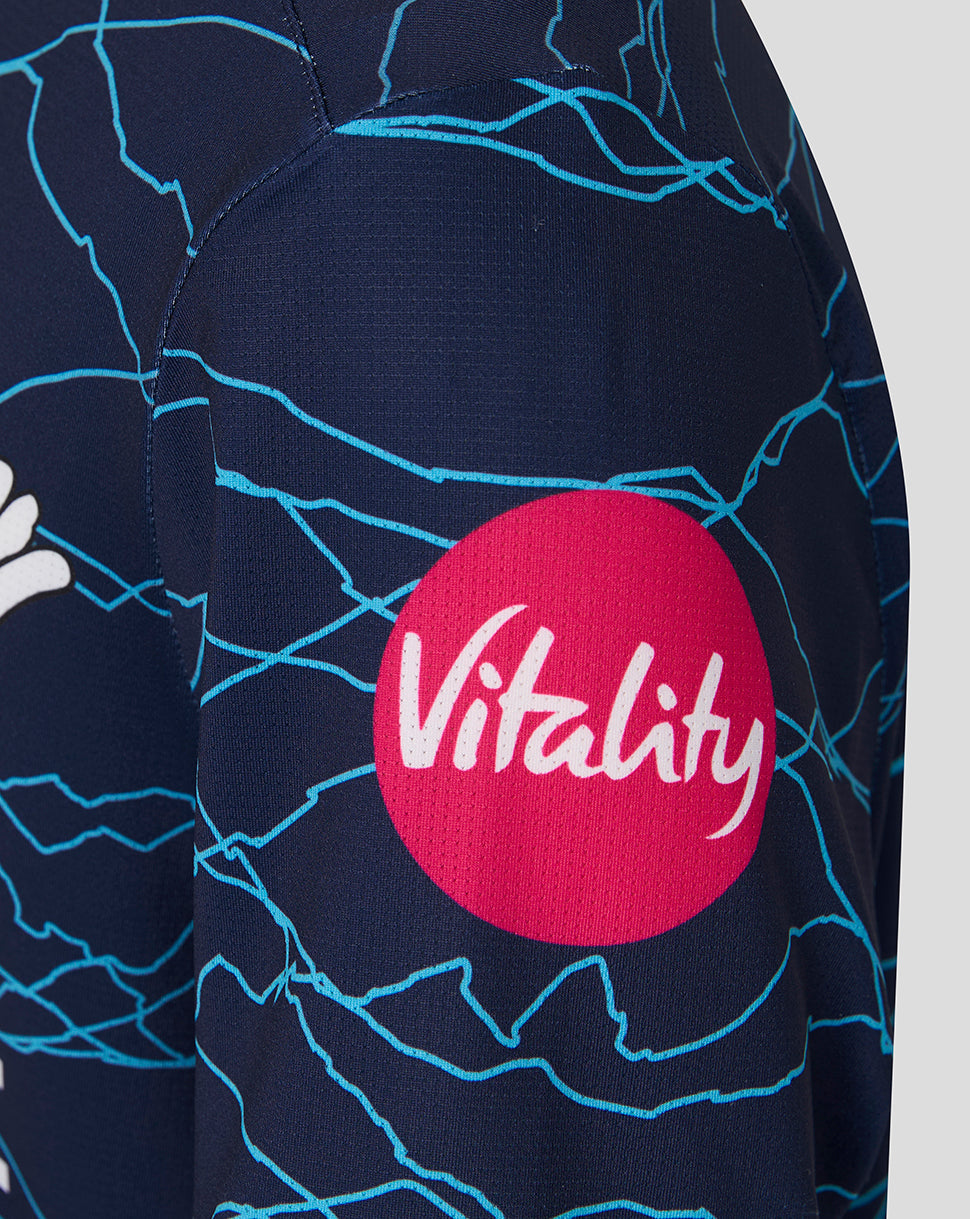 Navy blue fabric with blue patterns and a red circle logo with 'Vitality' text.
