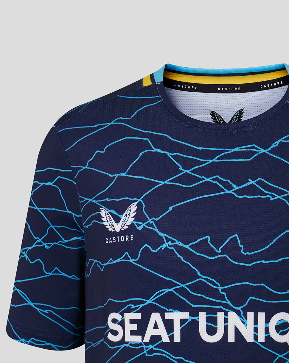 Navy blue sports jersey with blue patterns and 'Castore' branding on a light gray background