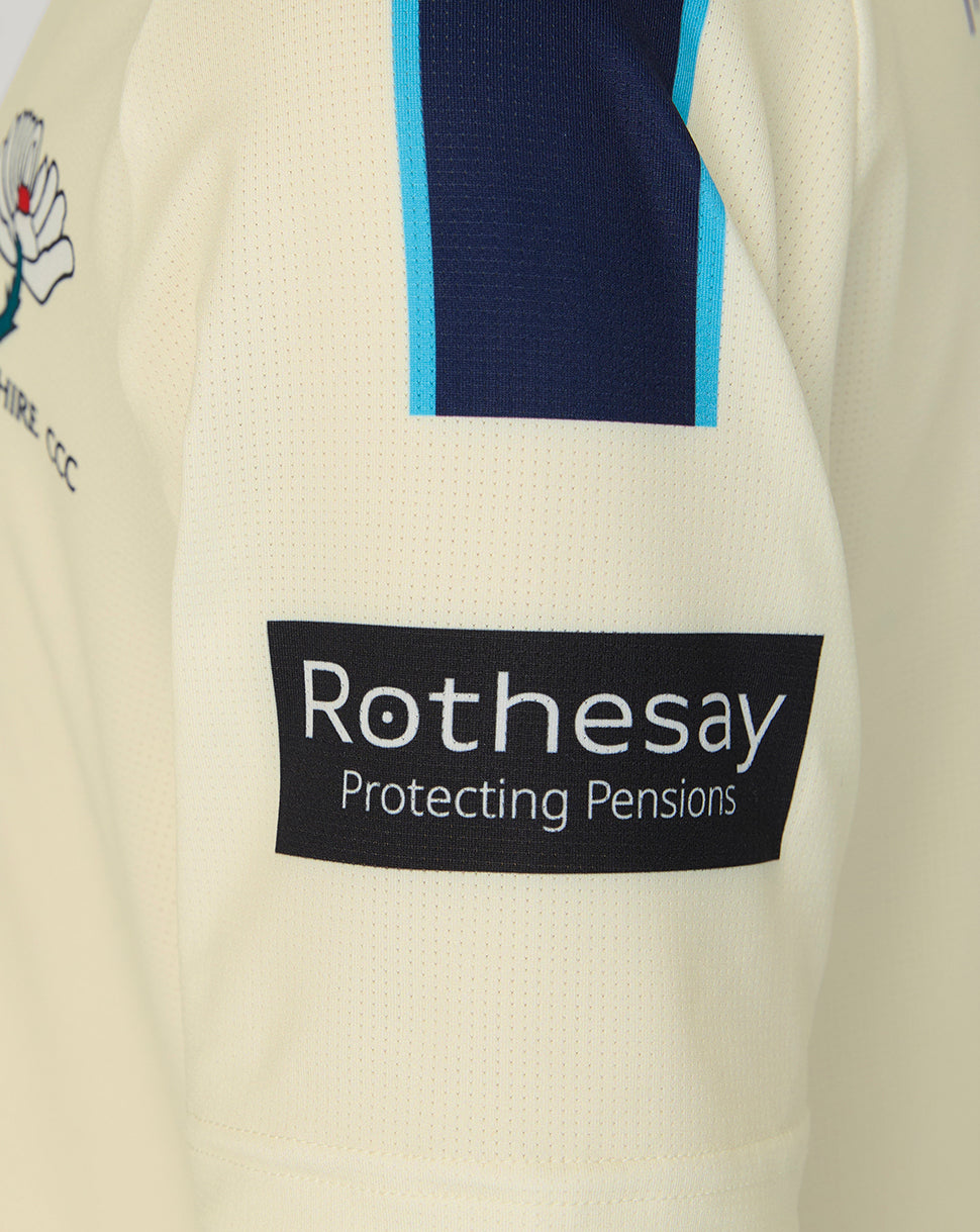 Close-up of a sports jersey with a Rothesay logo on a beige background