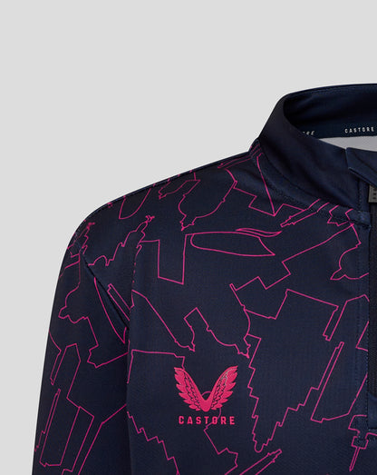 Navy shirt with pink abstract patterns and 'Castore' logo on a light gray background