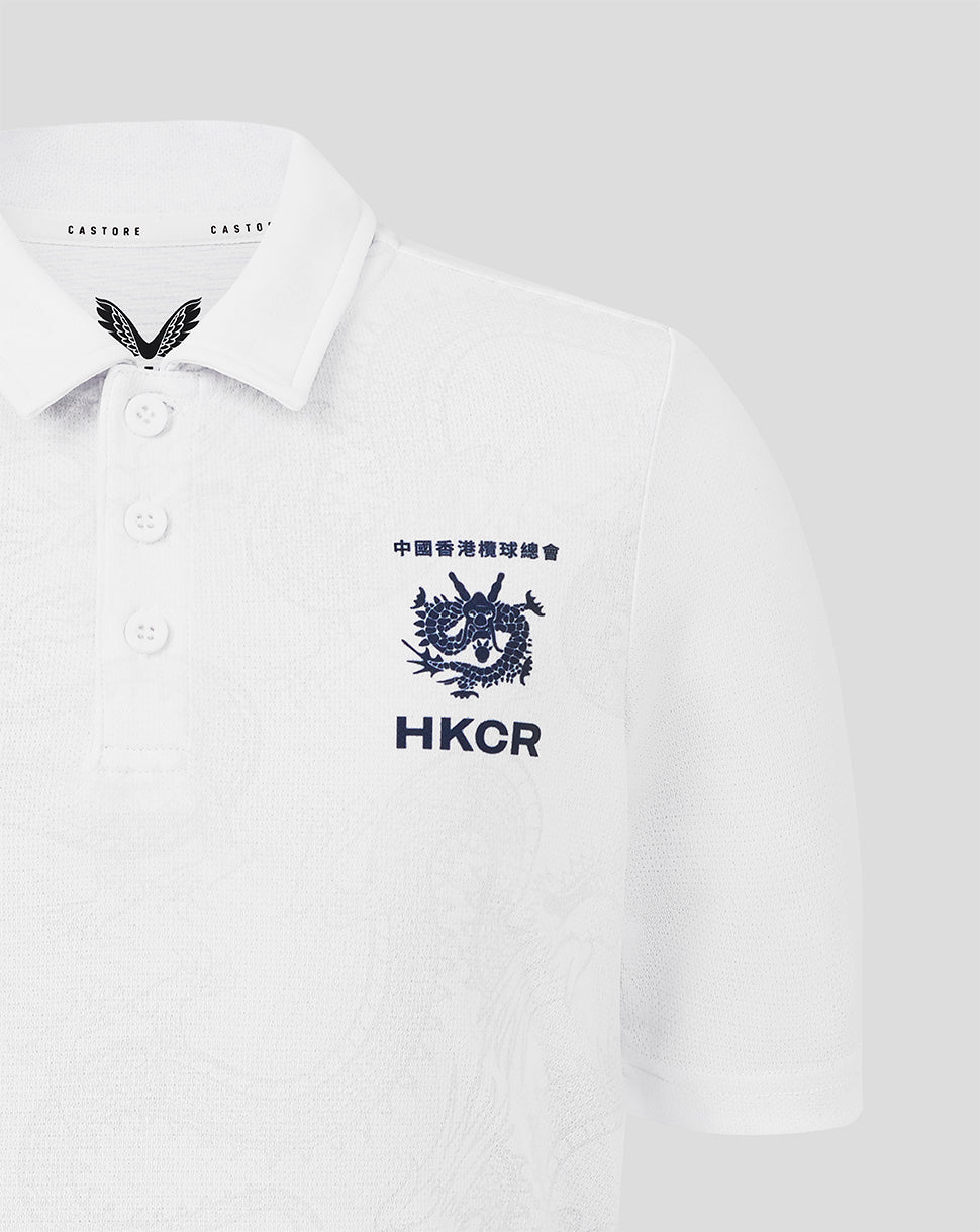 White polo shirt with embroidered logos on a light gray background