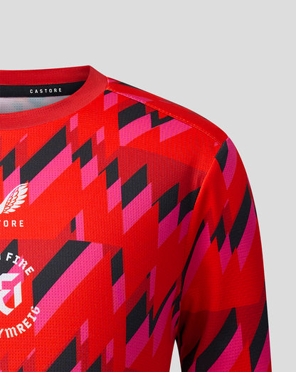 Close up of chest area on red Welsh Fire training T shirt displaying crest and geometric pattern
