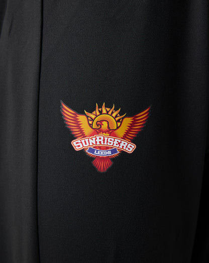 Close-up of the Sunrisers Leeds logo on black fabric of juniors pants