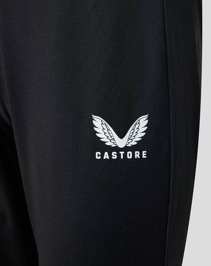 Close-up of white wing logo with Castore text on black pants