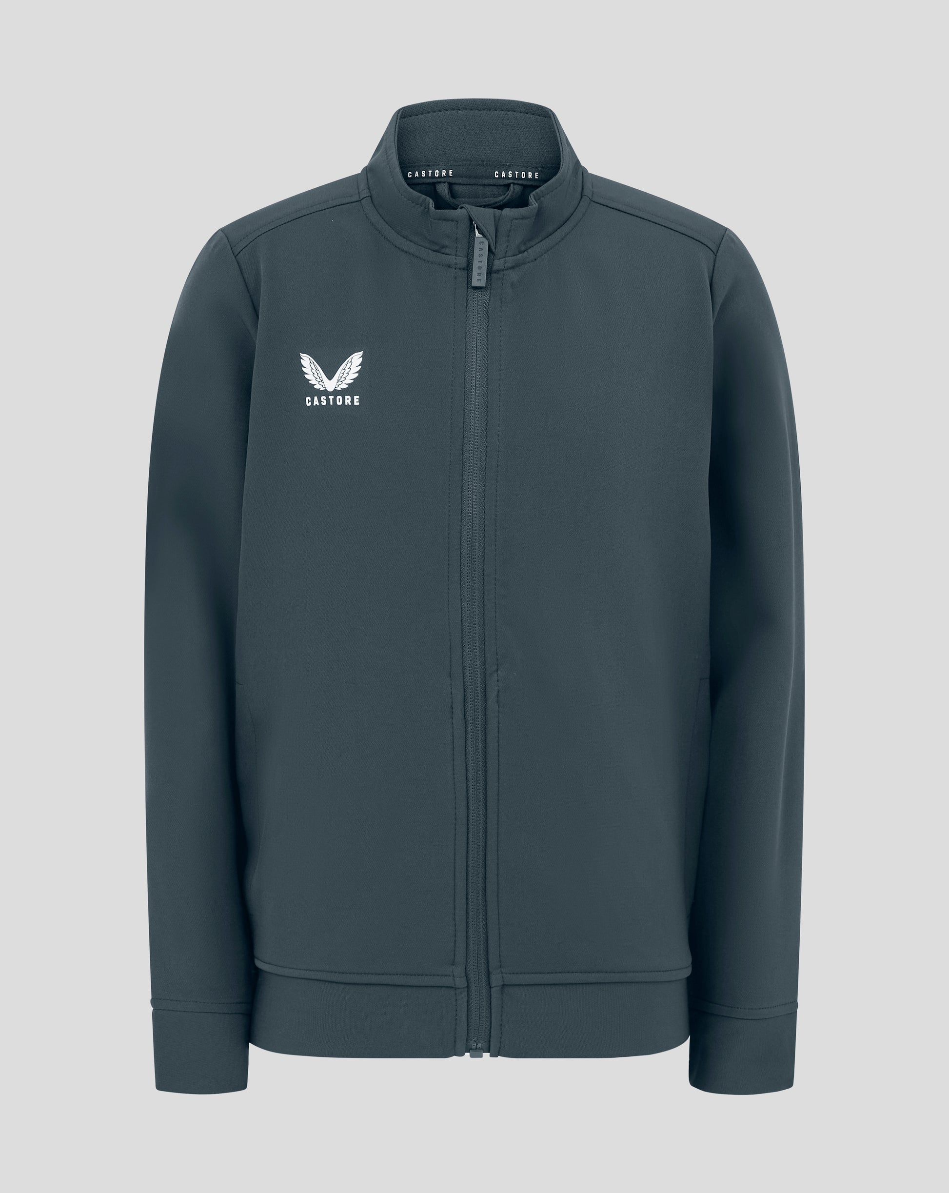 Front view of Junior Track Jacket in dark slate with funnel neck, full zip and Castore logo on chest.