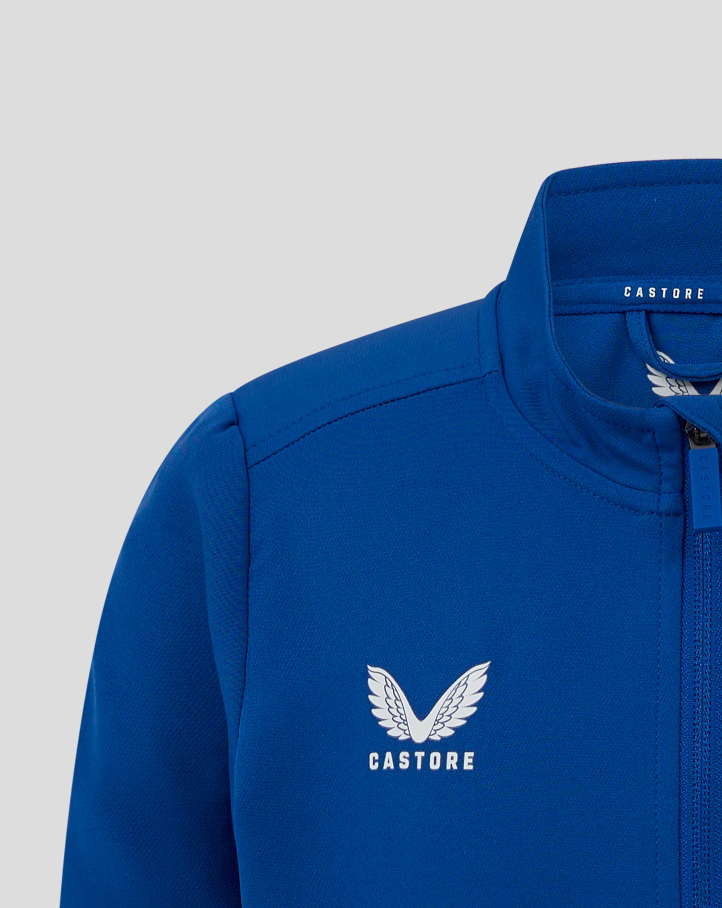 Close up of blue jacket collar with Castore branding on the back neck