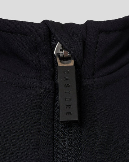 Close-up of zipper at the neckline of a black Castore jacket showing textured fabric and branding