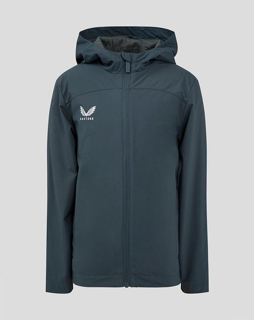 Junior rain jacket in dark slate with hood and front zipper and Castore logo on the left chest