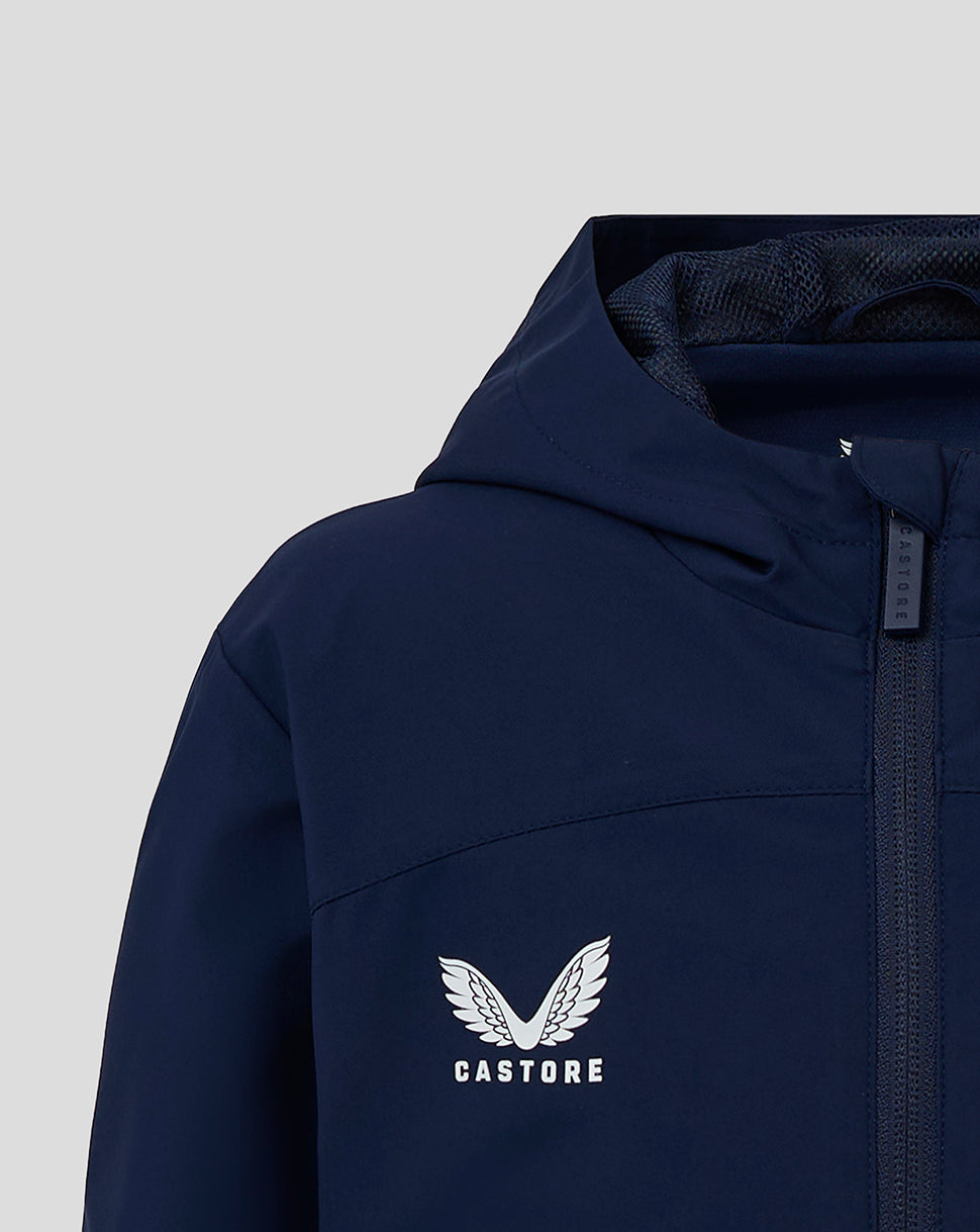 Close up of navy Junior Rain Jacket showing Castore logo on chest and front zipper.
