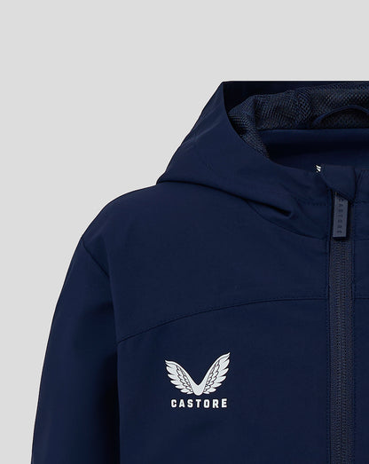 Close up of navy Junior Rain Jacket showing Castore logo on chest and front zipper.