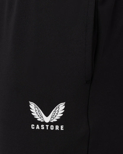 Close up of black fabric from Junior Slim Fit Pant with a white Castore wing logo at the hem